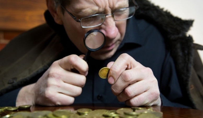 coin inspector checking a bullion coin
