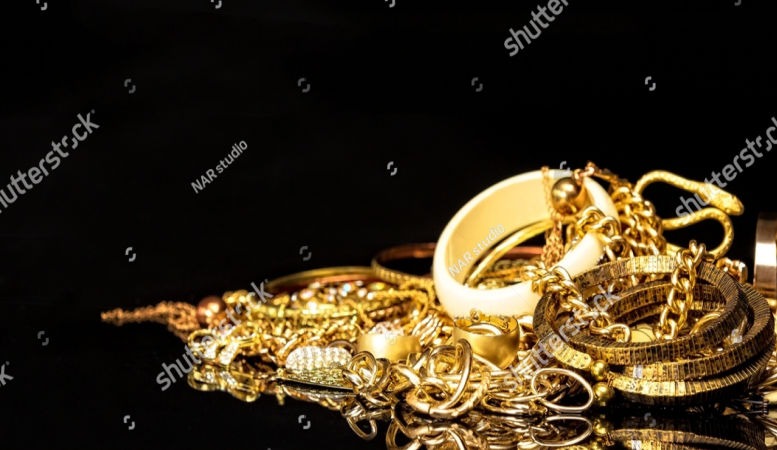 different gold jewelries in black background