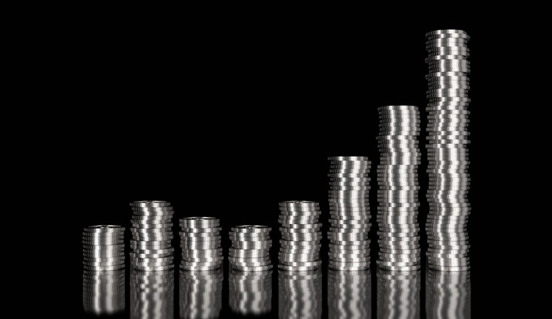 stack of silver coins in a dark background featured image