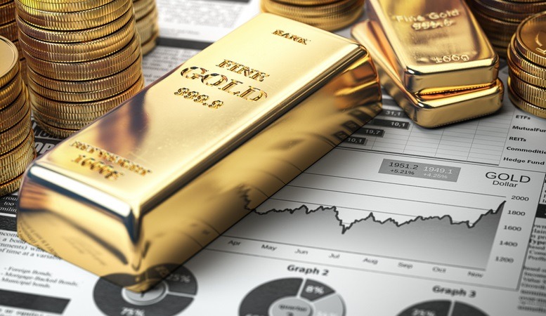 gold bars and coins at top of a financial report