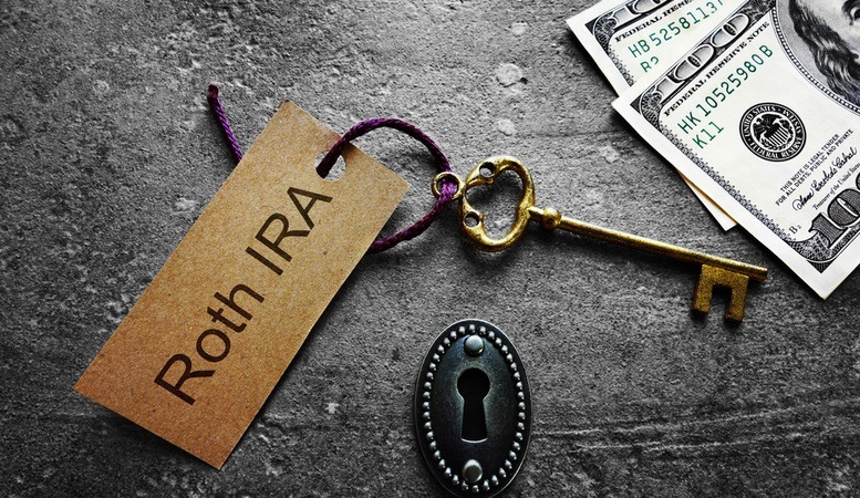 gold key with a written roth ira tag