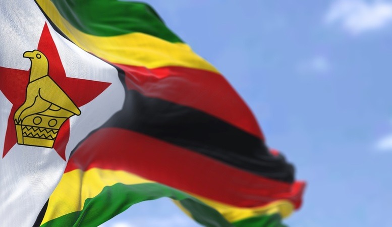 the zimbabwe flag raised in sky