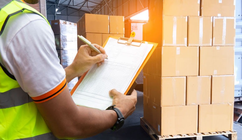 man listing all the package for shipment featured image