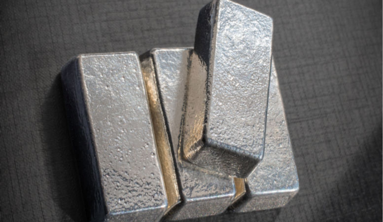 four bullion bars of palladium on gray background