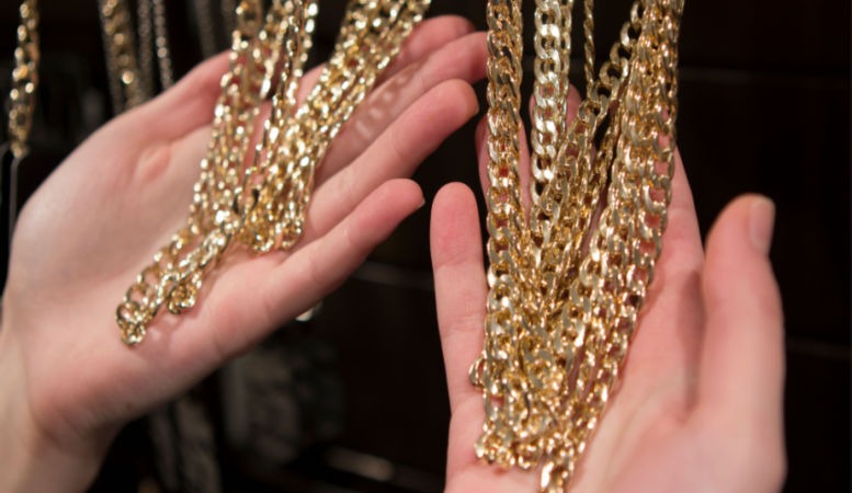 hands hold a lot of gold plated white gold from the store