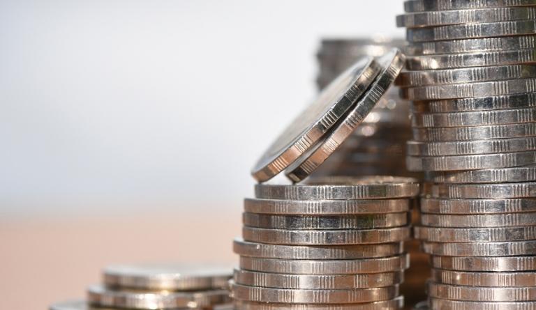 silver coins stack with a blurred background