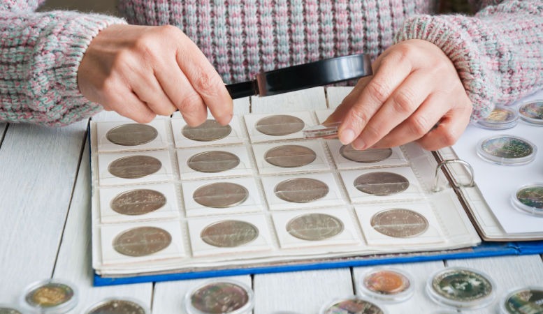 coin collectors checking coin if its legit