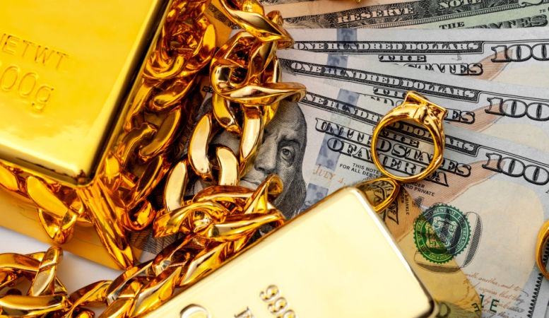 gold jewelries gold bars and pile of us dollar featured image