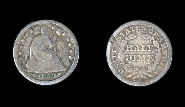 1853 seated liberty silver dime on black background