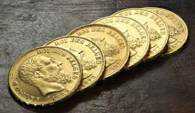 belgian franc gold coins on wooden background