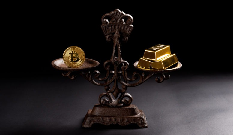 bitcoin and gold bars on balance scale