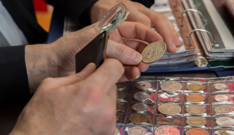numismatists examines collection of valuable dimes