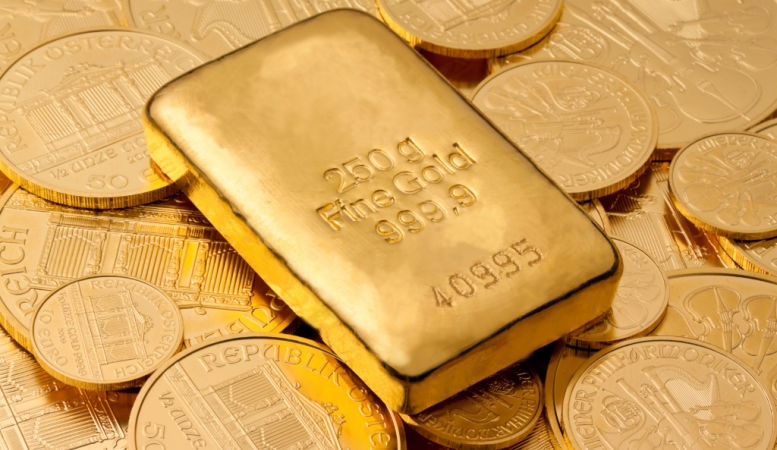 gold bar on top of pile of gold coins featured image