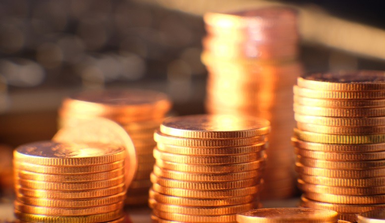 gold coins stacked with blurred background