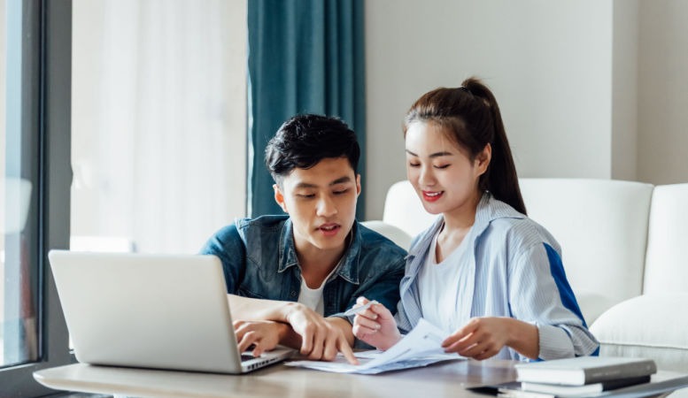 young couple working on gold and silver investment online