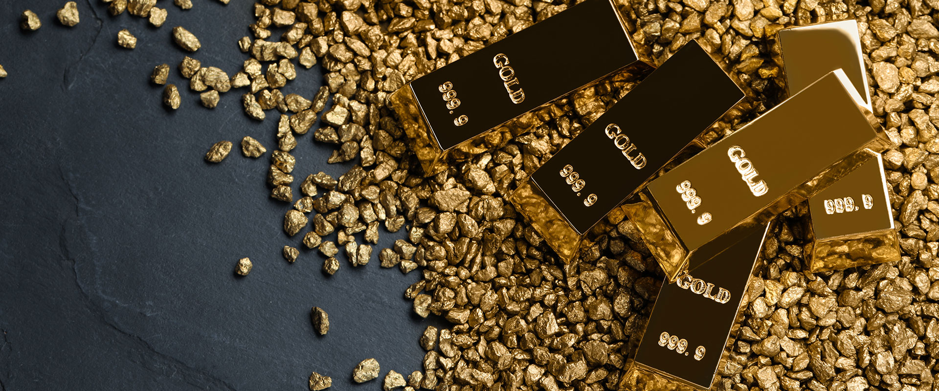 gold bars and gold nuggets on black background