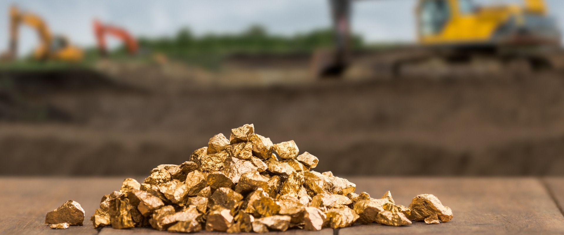 pile of gold nuggets on gold mining field