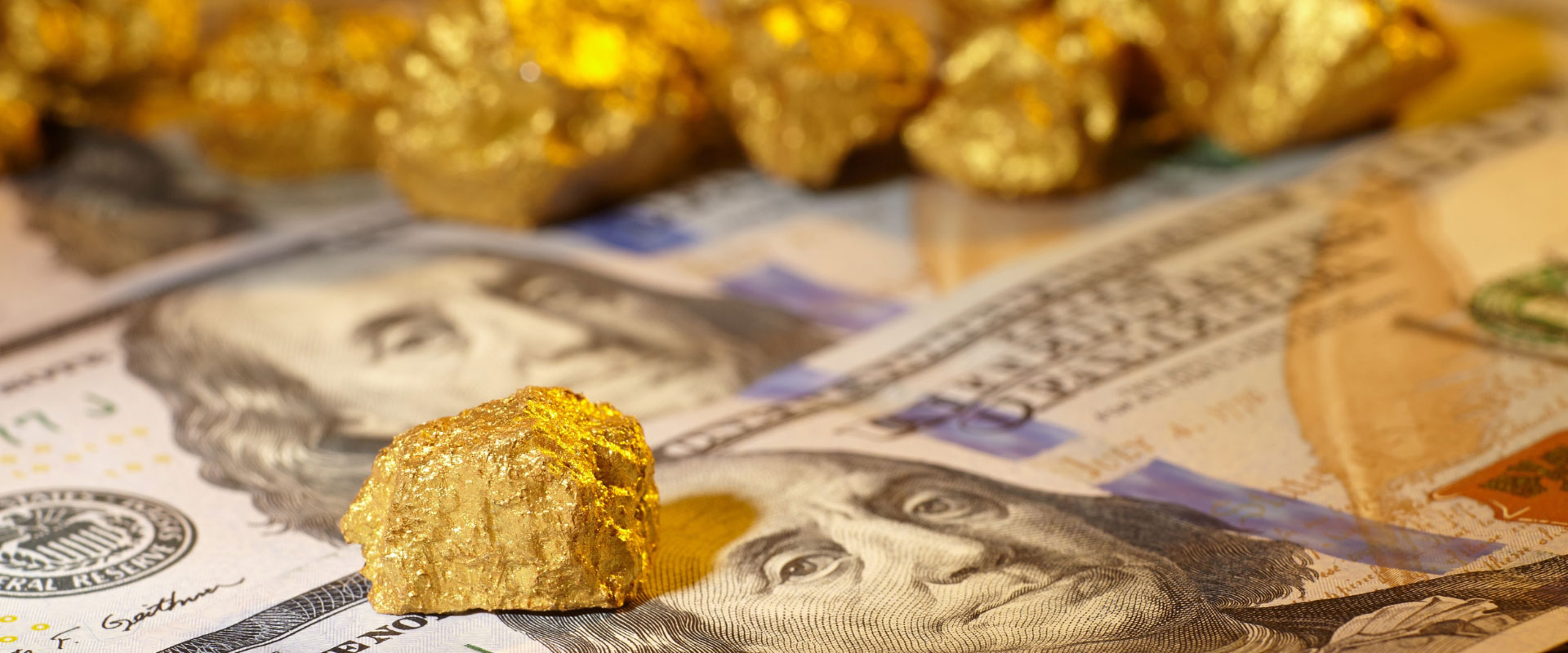 gold nuggets on dollar bills