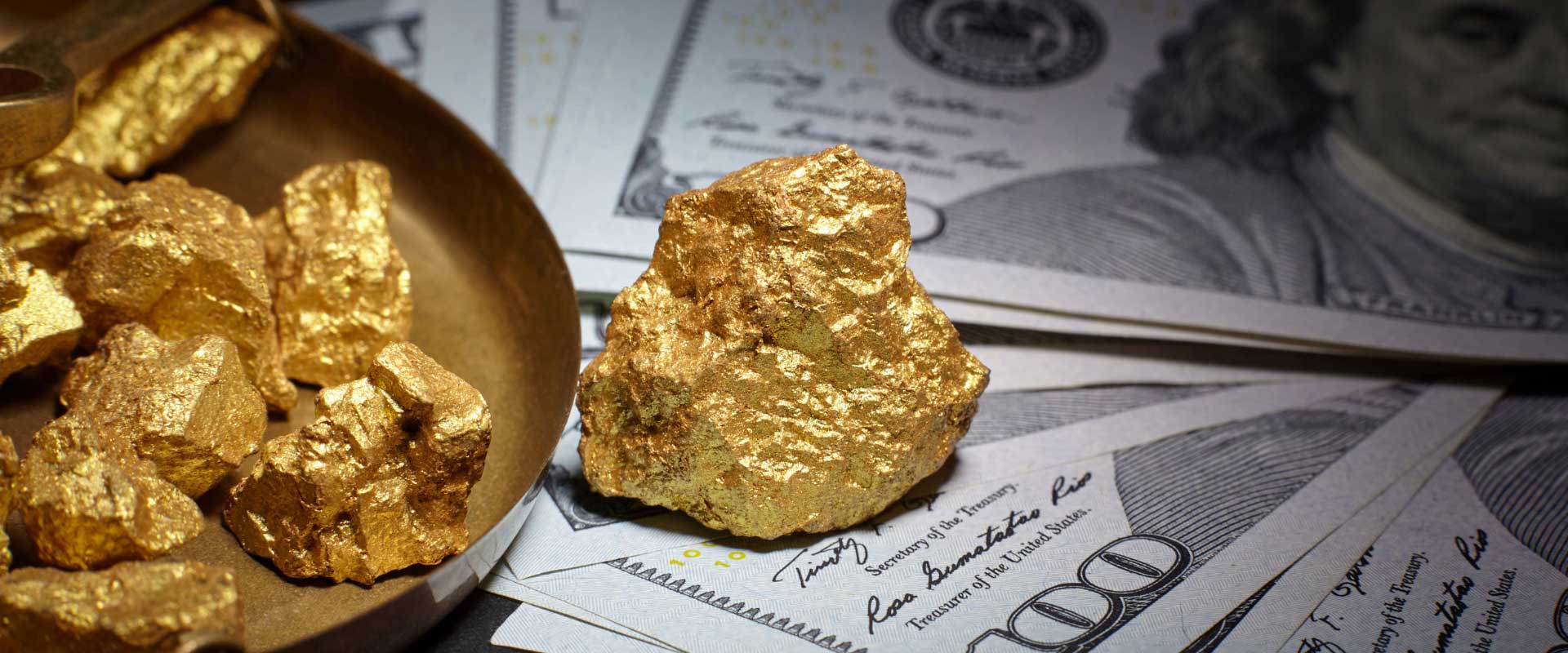 gold nuggets in one hundred dollar bill