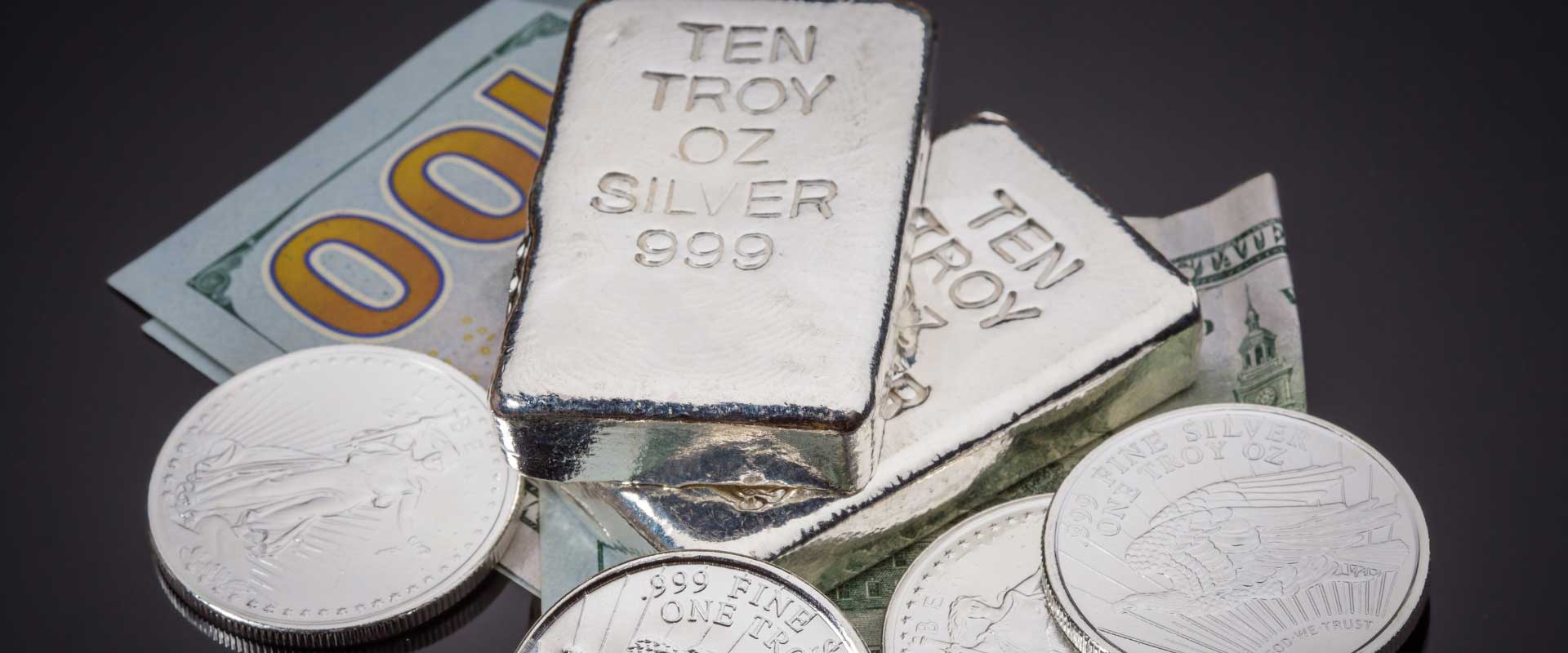 ten troy silver bars and silver coins on banknotes