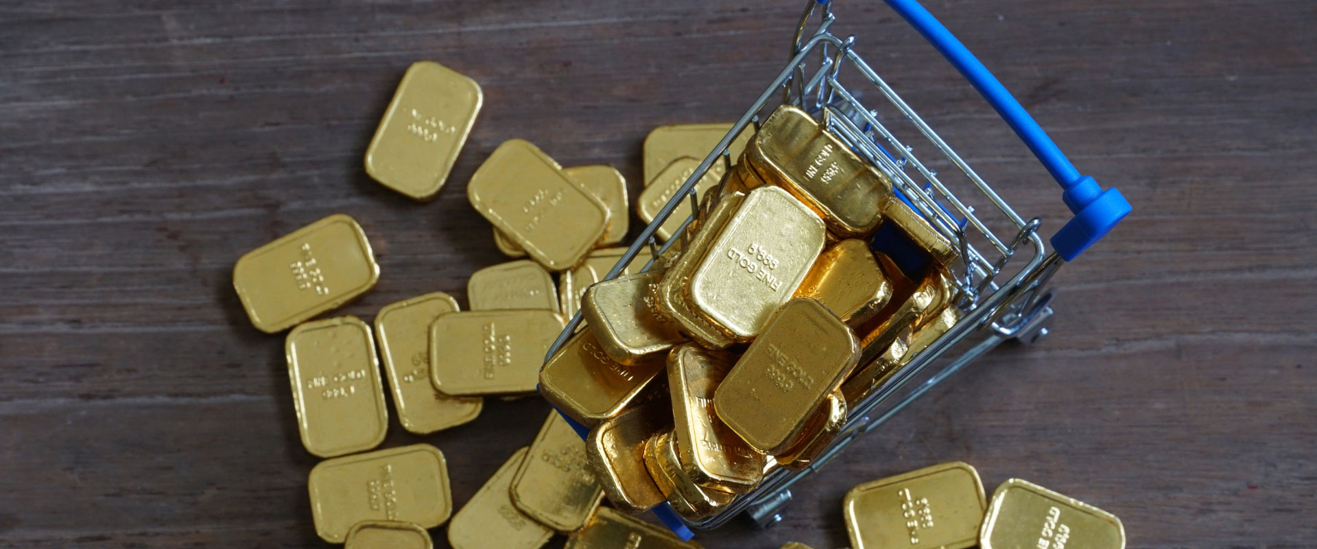 pile of gold bars in shopping cart