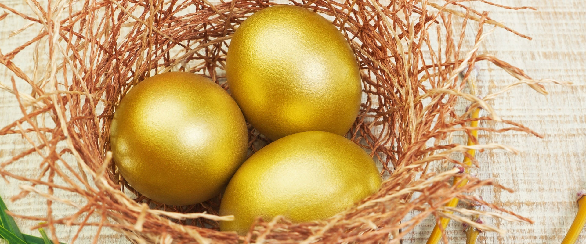 three gold eggs in a basket