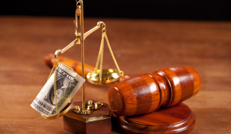 judge gavel and scale with dollar banknote