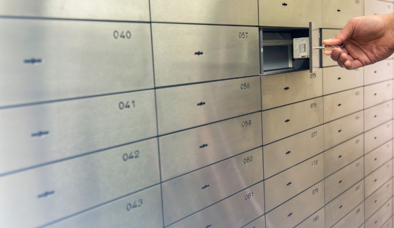 man opening safety deposit box in private depository