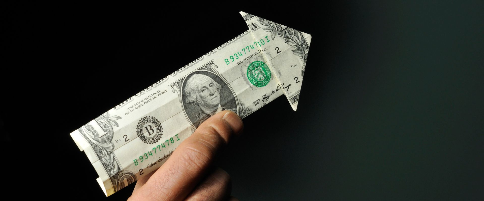 arrow made of dollar banknote pointing upward