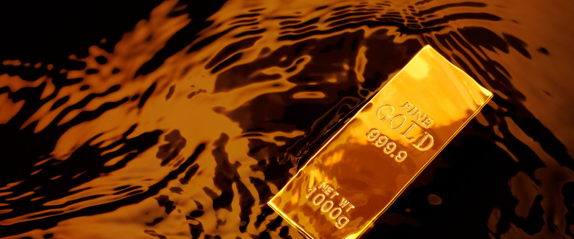 gold bullion on top of a liquid
