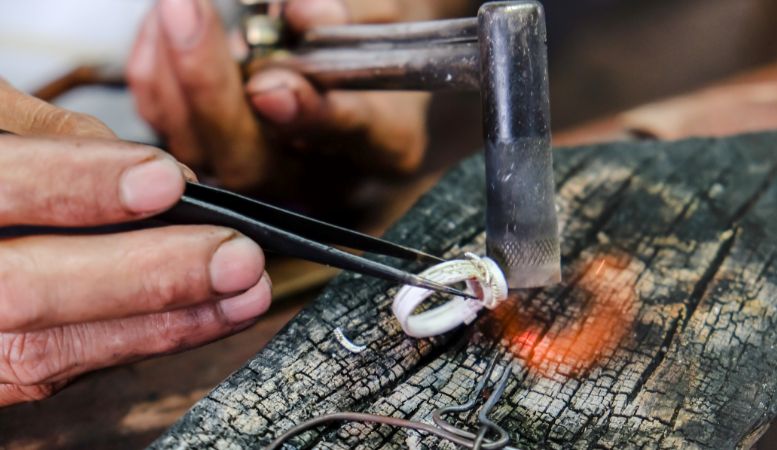 man making handmade silver ring