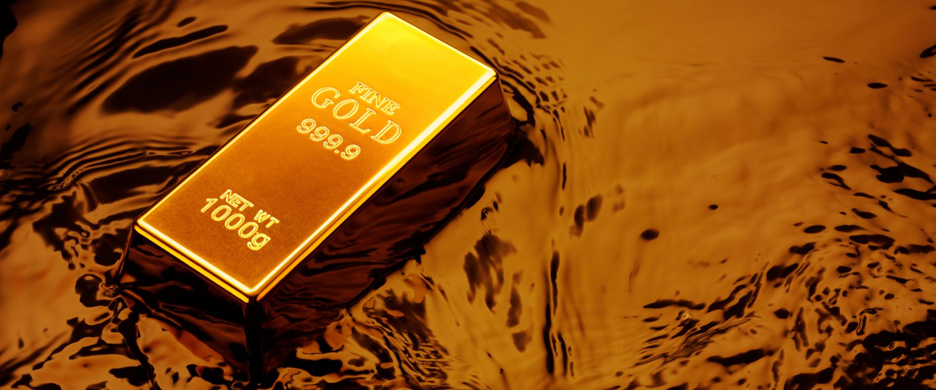 one thousand grams fine gold bar on top of liquid