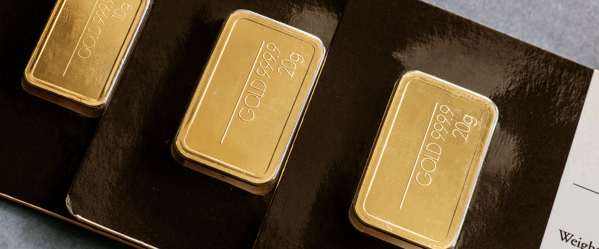 several minted gold bars in different weight