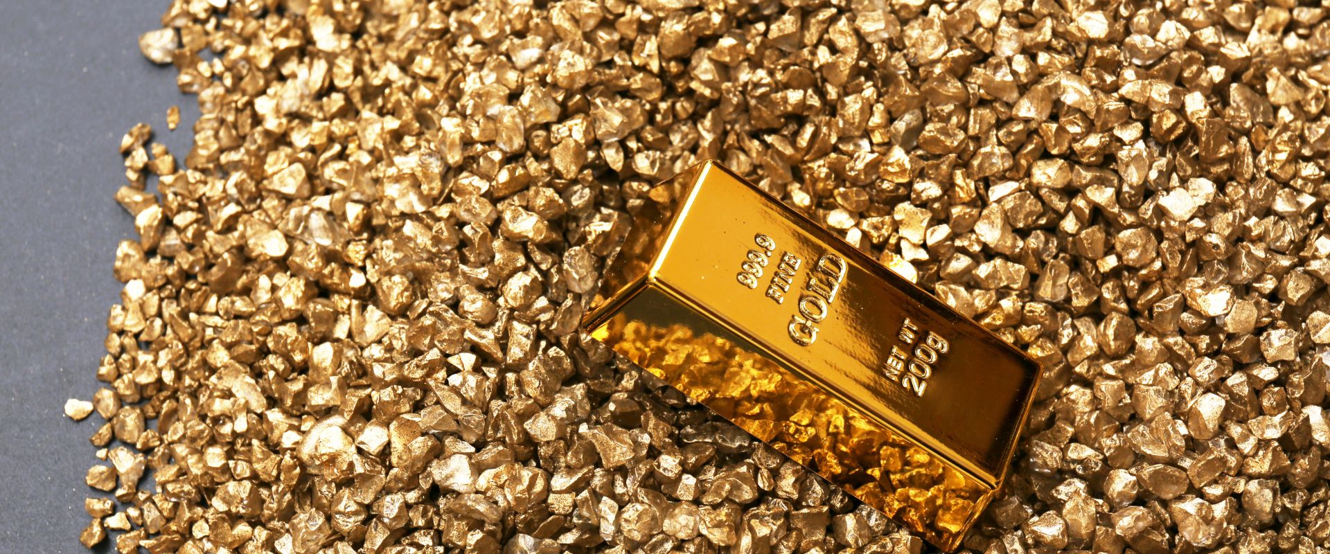 two hundred grams gold bar on gold nuggets