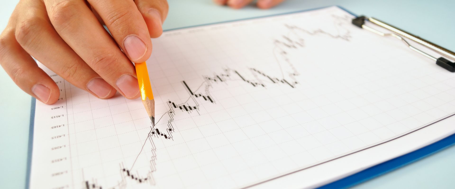 man analyzing an upward market trend graph