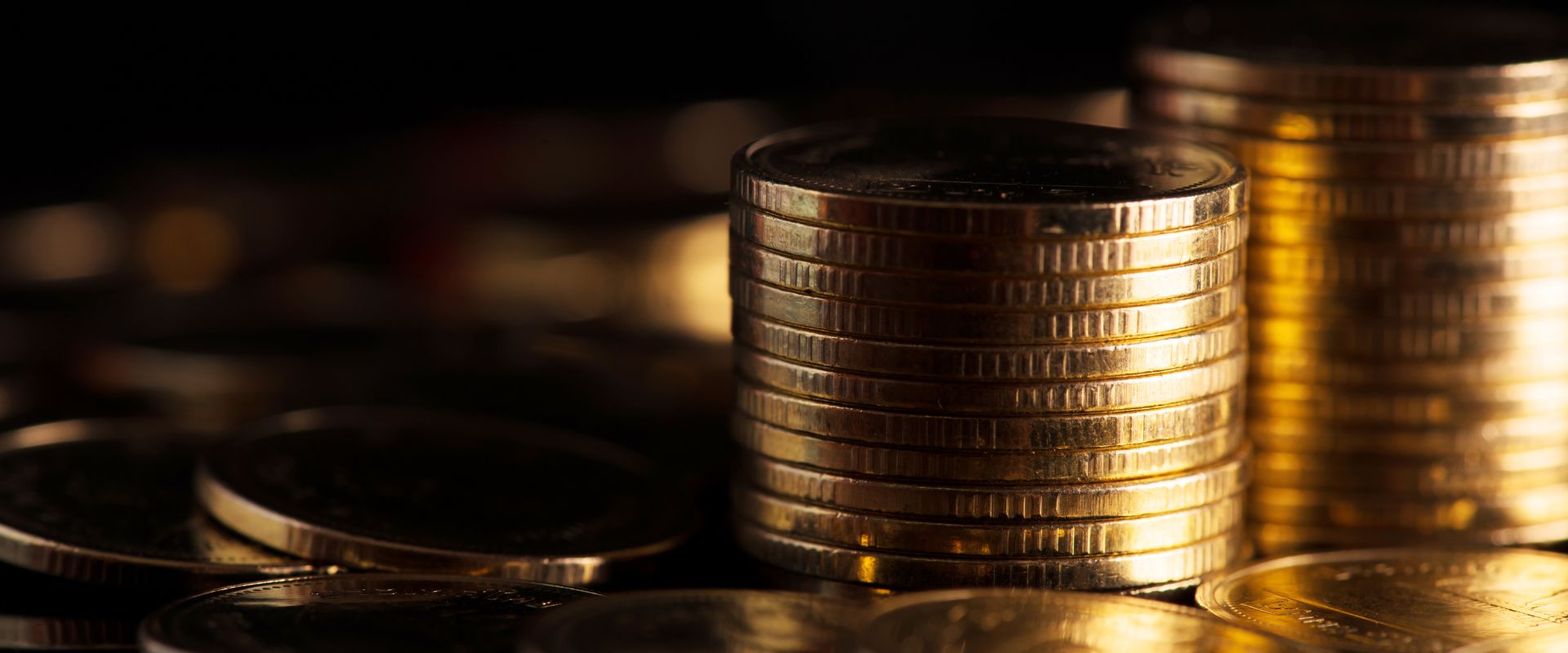 stack of gold coins on a dark background