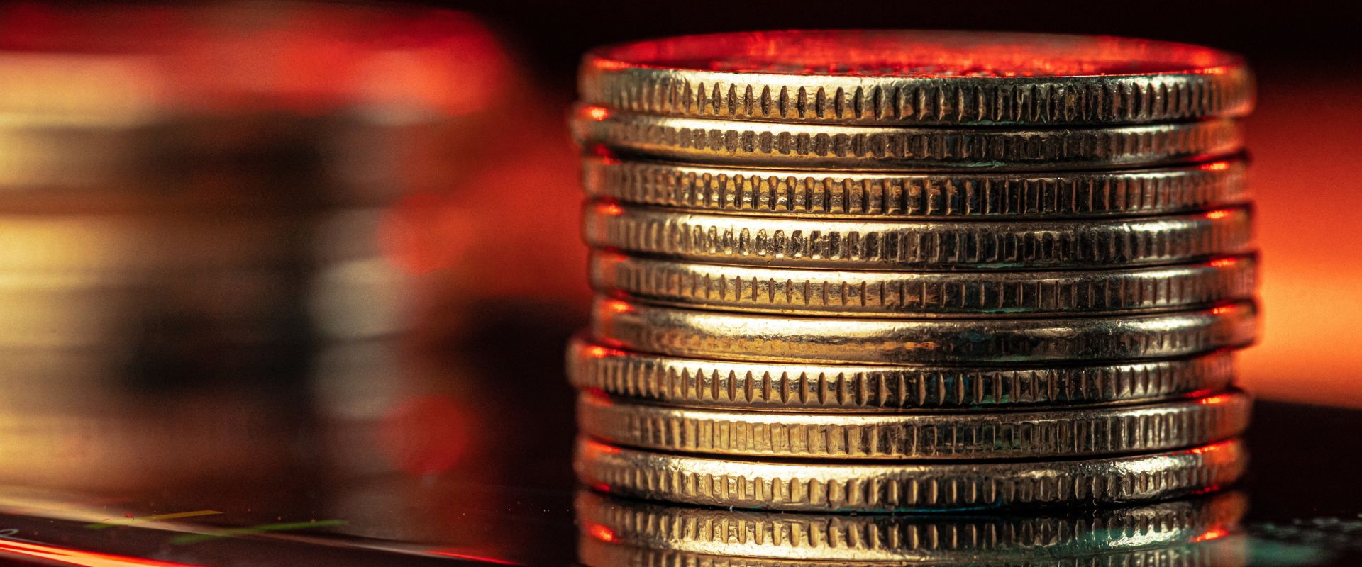 gold coins stack equally in blurred background