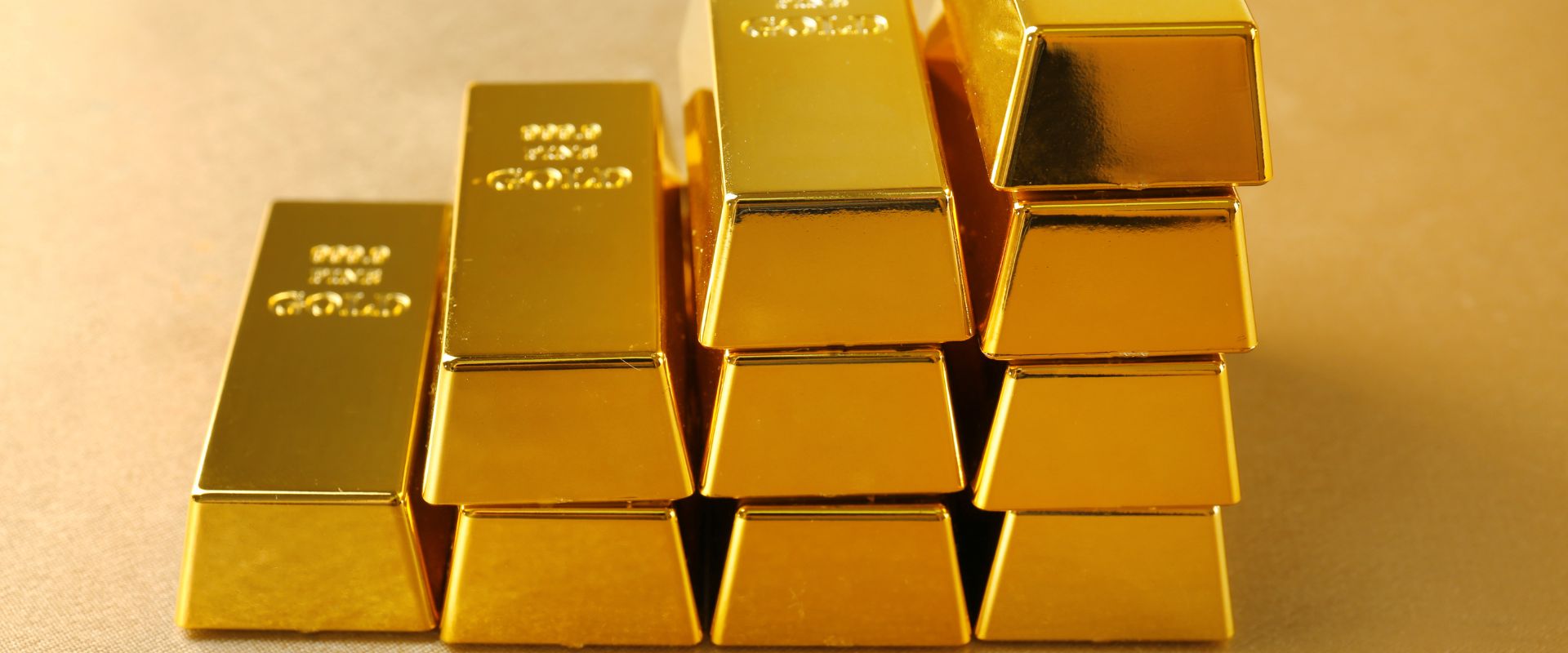 raising stack of fine gold bars