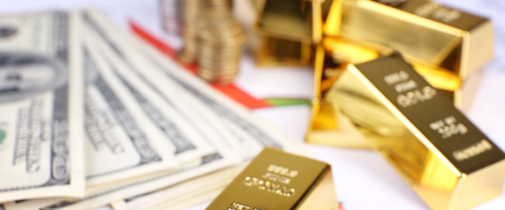 gold bars with dollar banknotes on paper