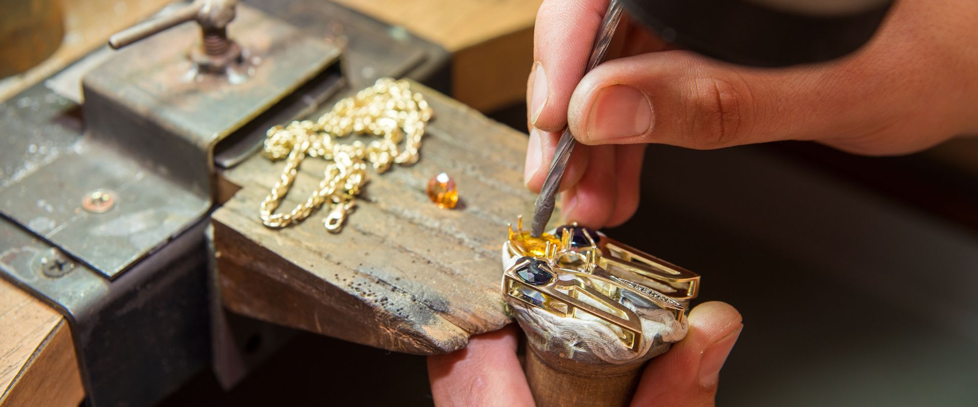 jeweler making gold jewelry with stone