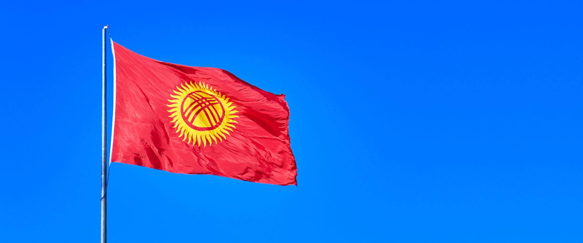 waving flag of Kyrgyzstan on sky background
