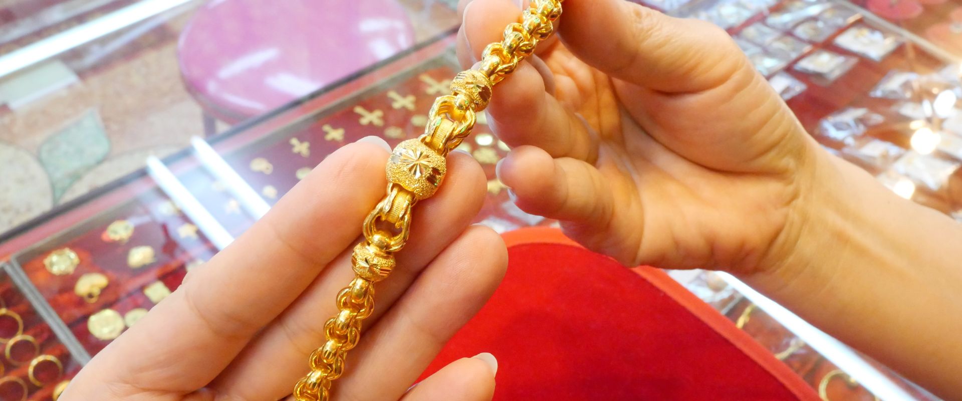 woman selling gold bracelet at pawn shop