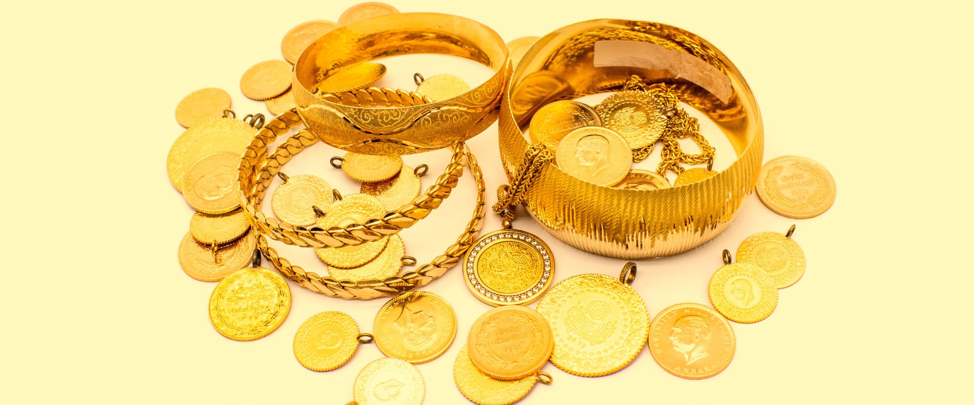 gold coins bracelet and necklace on yellow background