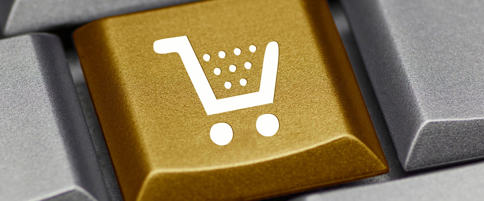 gold computer key with shopping cart icon