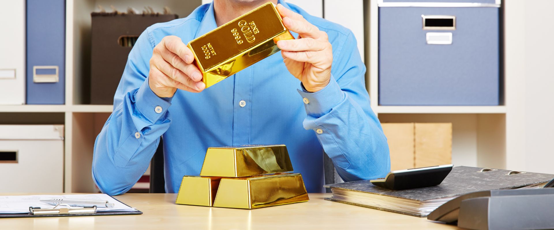 investor holding gold bar in office